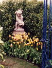 Stone dolphin boy with tulips